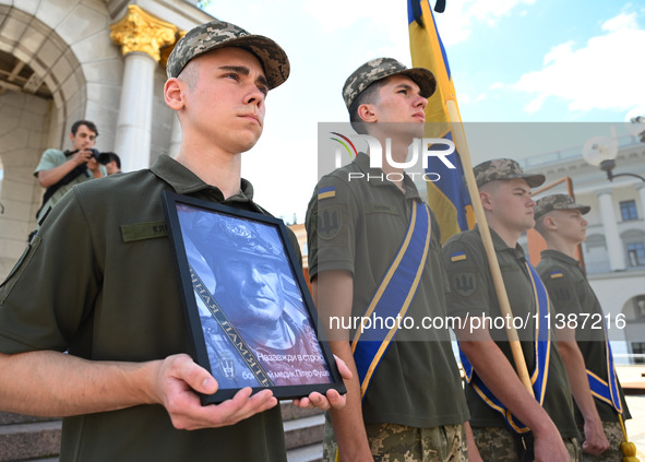 People are taking part in a funeral ceremony for British volunteer and combat medic Peter Fouche at Independence Square in Kyiv, Ukraine, on...