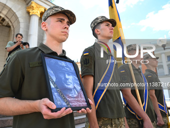 People are taking part in a funeral ceremony for British volunteer and combat medic Peter Fouche at Independence Square in Kyiv, Ukraine, on...