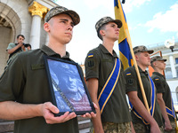 People are taking part in a funeral ceremony for British volunteer and combat medic Peter Fouche at Independence Square in Kyiv, Ukraine, on...