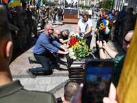 People are taking part in a funeral ceremony for British volunteer and combat medic Peter Fouche at Independence Square in Kyiv, Ukraine, on...