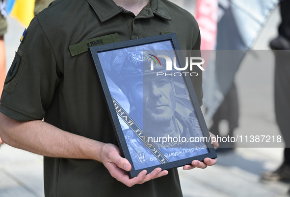 A portrait of British volunteer and combat medic Peter Fouche is being seen during his funeral ceremony at Independence Square in Kyiv, Ukra...