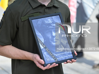 A portrait of British volunteer and combat medic Peter Fouche is being seen during his funeral ceremony at Independence Square in Kyiv, Ukra...