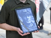 A portrait of British volunteer and combat medic Peter Fouche is being seen during his funeral ceremony at Independence Square in Kyiv, Ukra...