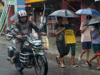 People are being seen during a continuous rainfall in Siliguri, India, on July 6, 2024. (