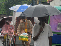 People are being seen during a continuous rainfall in Siliguri, India, on July 6, 2024. (