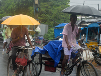 People are being seen during a continuous rainfall in Siliguri, India, on July 6, 2024. (