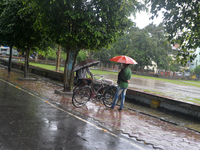 People are being seen during a continuous rainfall in Siliguri, India, on July 6, 2024. (