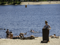 People are relaxing on the beach on the banks of the Dnipro River in Kyiv, Ukraine, on July 06, 2024. Heatwaves of up to 40 degrees Celsius...