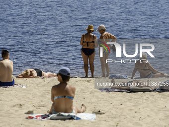 People are relaxing on the beach on the banks of the Dnipro River in Kyiv, Ukraine, on July 06, 2024. Heatwaves of up to 40 degrees Celsius...