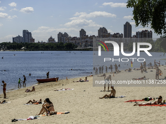 People are relaxing on the beach on the banks of the Dnipro River in Kyiv, Ukraine, on July 06, 2024. Heatwaves of up to 40 degrees Celsius...