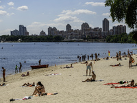 People are relaxing on the beach on the banks of the Dnipro River in Kyiv, Ukraine, on July 06, 2024. Heatwaves of up to 40 degrees Celsius...