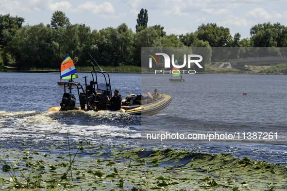 A rescue boat is standing guard near the beach on the banks of the Dnipro River in Kyiv, Ukraine, on July 06, 2024 