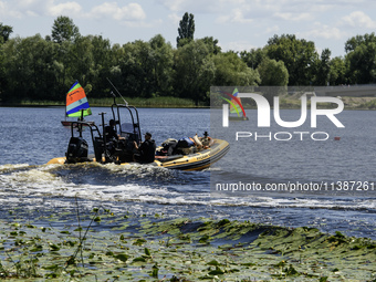 A rescue boat is standing guard near the beach on the banks of the Dnipro River in Kyiv, Ukraine, on July 06, 2024 (