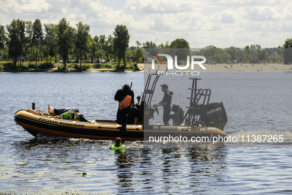 A rescue boat is standing guard near the beach on the banks of the Dnipro River in Kyiv, Ukraine, on July 06, 2024 