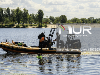 A rescue boat is standing guard near the beach on the banks of the Dnipro River in Kyiv, Ukraine, on July 06, 2024 (