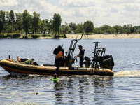 A rescue boat is standing guard near the beach on the banks of the Dnipro River in Kyiv, Ukraine, on July 06, 2024 (