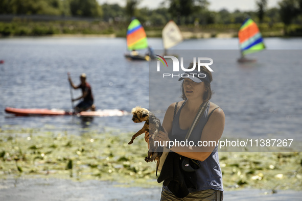 People are relaxing on the beach on the banks of the Dnipro River in Kyiv, Ukraine, on July 06, 2024. Heatwaves of up to 40 degrees Celsius...