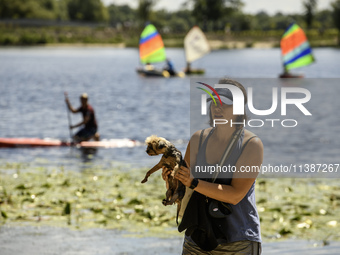 People are relaxing on the beach on the banks of the Dnipro River in Kyiv, Ukraine, on July 06, 2024. Heatwaves of up to 40 degrees Celsius...