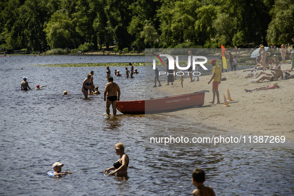 People are relaxing on the beach on the banks of the Dnipro River in Kyiv, Ukraine, on July 06, 2024. Heatwaves of up to 40 degrees Celsius...