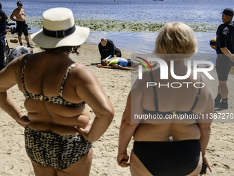 Rescuers are conducting a drowning exercise at a beach on the banks of the Dnipro River in Kyiv, Ukraine, on July 06, 2024 (