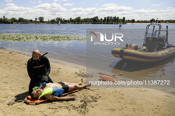 Rescuers are conducting a drowning exercise at a beach on the banks of the Dnipro River in Kyiv, Ukraine, on July 06, 2024 