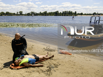 Rescuers are conducting a drowning exercise at a beach on the banks of the Dnipro River in Kyiv, Ukraine, on July 06, 2024 (