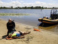 Rescuers are conducting a drowning exercise at a beach on the banks of the Dnipro River in Kyiv, Ukraine, on July 06, 2024 (