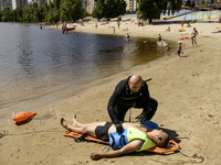 Rescuers are conducting a drowning exercise at a beach on the banks of the Dnipro River in Kyiv, Ukraine, on July 06, 2024 (