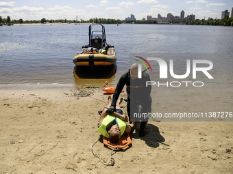 Rescuers are conducting a drowning exercise at a beach on the banks of the Dnipro River in Kyiv, Ukraine, on July 06, 2024 (