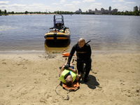 Rescuers are conducting a drowning exercise at a beach on the banks of the Dnipro River in Kyiv, Ukraine, on July 06, 2024 (