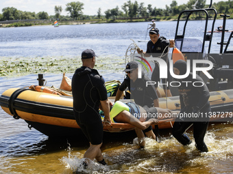 Rescuers are conducting a drowning exercise at a beach on the banks of the Dnipro River in Kyiv, Ukraine, on July 06, 2024 (