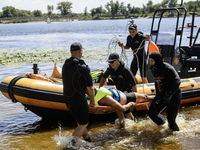 Rescuers are conducting a drowning exercise at a beach on the banks of the Dnipro River in Kyiv, Ukraine, on July 06, 2024 (