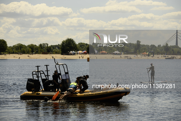 Rescuers are conducting a drowning exercise at a beach on the banks of the Dnipro River in Kyiv, Ukraine, on July 06, 2024 