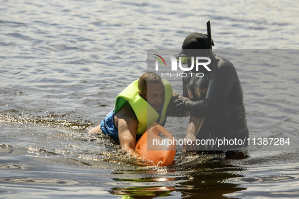 Rescuers are conducting a drowning exercise at a beach on the banks of the Dnipro River in Kyiv, Ukraine, on July 06, 2024 