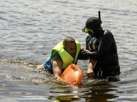 Rescuers are conducting a drowning exercise at a beach on the banks of the Dnipro River in Kyiv, Ukraine, on July 06, 2024 (