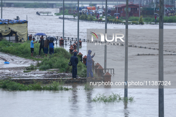 Nepali citizens are watching the rising level of Bagmati River in Kathmandu, Nepal, on July 6, 2024. 