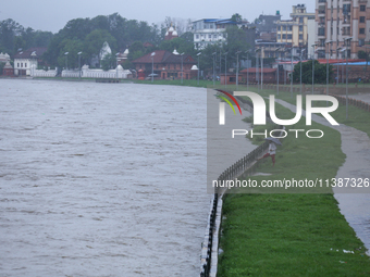 A Nepali citizen is standing on the embankments of the overflowing Bagmati river in Lalitpur, Nepal, on July 6, 2024. With the onset of the...