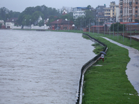 A Nepali citizen is standing on the embankments of the overflowing Bagmati river in Lalitpur, Nepal, on July 6, 2024. With the onset of the...