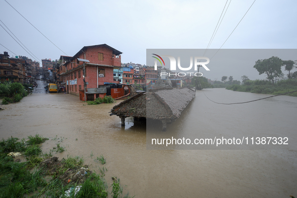 A ''Falcha,'' also called a public rest place, is being submerged in water as the Hanumante River is bursting its embankments after heavy ra...