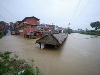 A ''Falcha,'' also called a public rest place, is being submerged in water as the Hanumante River is bursting its embankments after heavy ra...