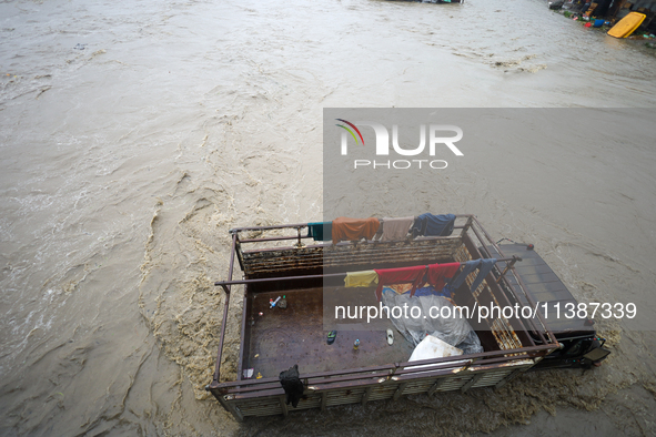 A transport truck is being submerged by a flooded river in Kathmandu, Nepal, on July 6, 2024. 