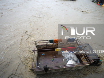 A transport truck is being submerged by a flooded river in Kathmandu, Nepal, on July 6, 2024. (