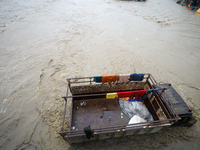 A transport truck is being submerged by a flooded river in Kathmandu, Nepal, on July 6, 2024. (