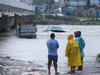 Nepali citizens are watching the rising level of Bagmati River in Kathmandu, Nepal, on July 6, 2024. (