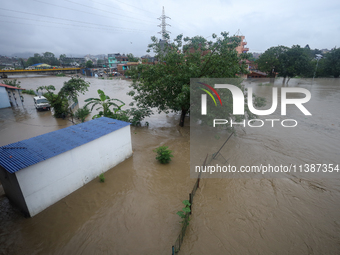 Flooding is submerging a section of road in Kathmandu, Nepal, on July 6, 2024. (