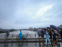 Nepali citizens are watching the rising level of Bagmati River in Kathmandu, Nepal, on July 6, 2024. (