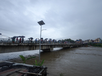 Nepali citizens are watching the rising level of Bagmati River in Kathmandu, Nepal, on July 6, 2024. (