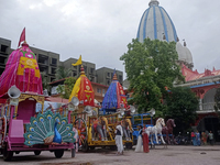 Devotees are standing near the decorated Rath (Chariot) at ISKCON Temple premises on the eve of the Rath Yatra in Siliguri, India, on July 6...