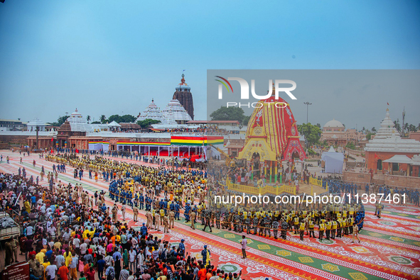 Newly built wooden chariots of Lord Balabhadra, Devi Subhadra, and Lord Jagannath are being seen in front of the Shree Jagannath Temple on t...