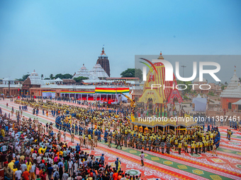 Newly built wooden chariots of Lord Balabhadra, Devi Subhadra, and Lord Jagannath are being seen in front of the Shree Jagannath Temple on t...